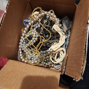 Box of vintage costume jewelry and gold chains. Approx 30 necklaces.